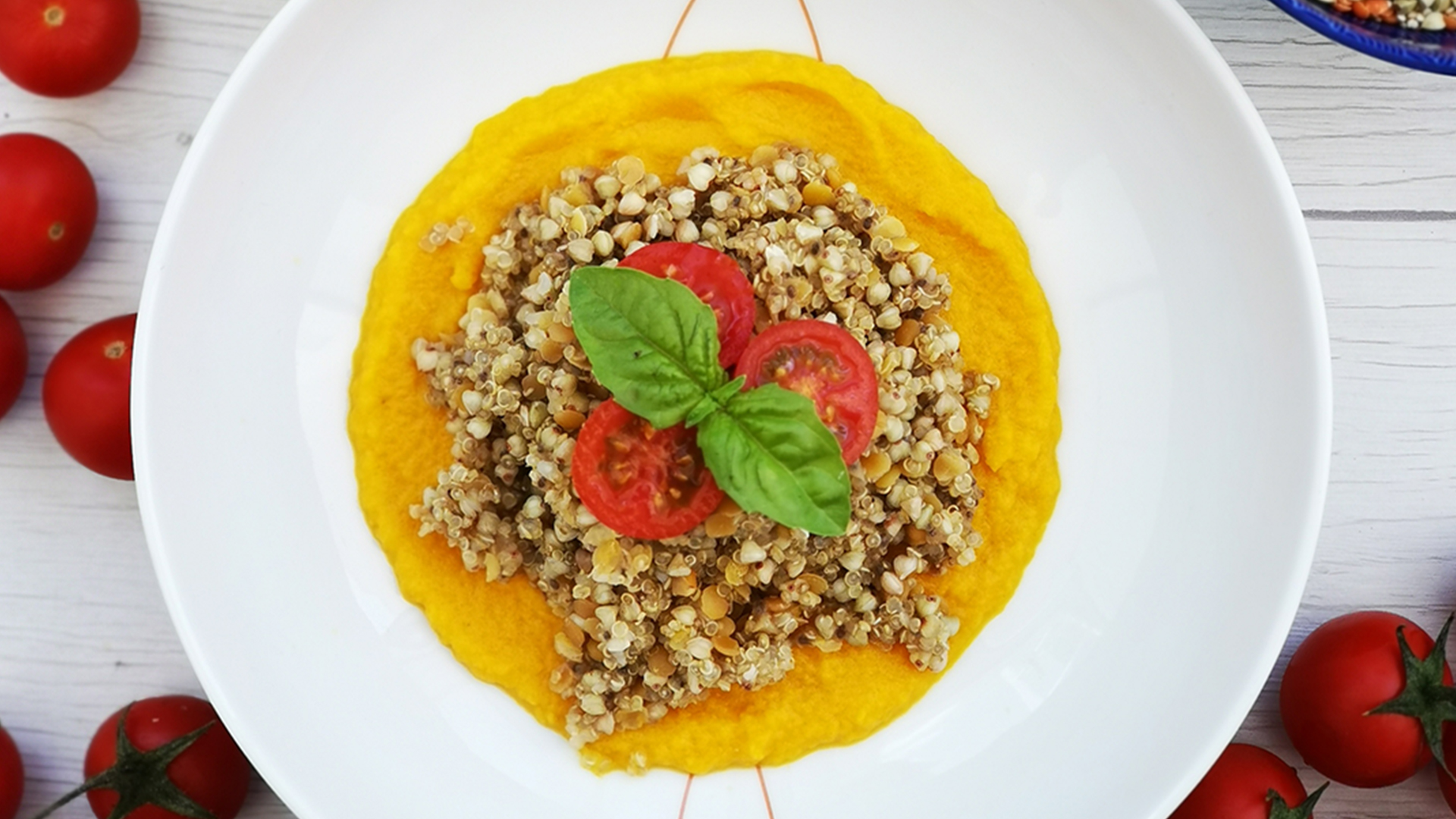 Insalata di quinoa e grano saraceno con lenticchie rosse e chia su crema di zucca, pomodorini e basilico